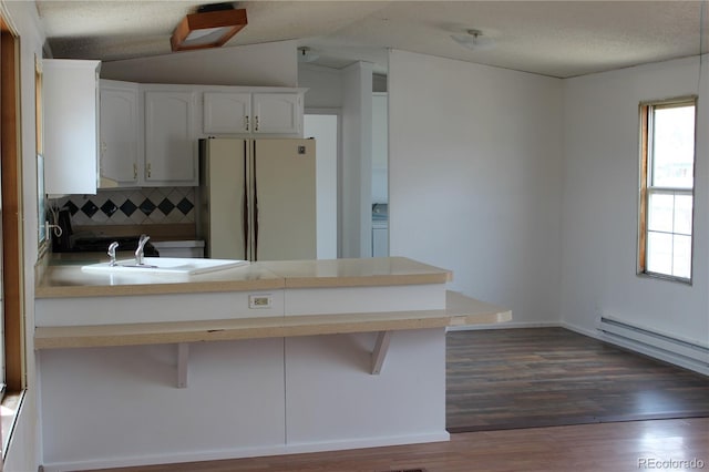 1692 US Highway 24, Leadville, CO 80461 - kitchen with freestanding refrigerator, a peninsula, a sink, decorative backsplash, and dark wood-type flooring