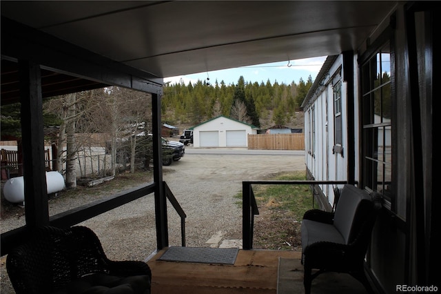 1692 US Highway 24, Leadville, CO 80461 - view of patio / terrace with a wooded view, a garage, an outbuilding, and fence