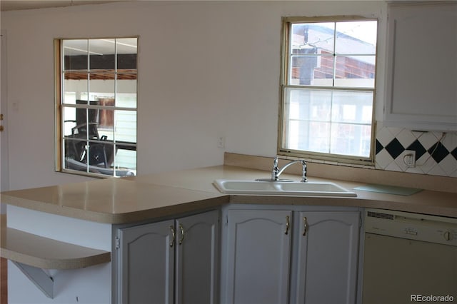1692 US Highway 24, Leadville, CO 80461 - kitchen featuring white dishwasher, a sink, tasteful backsplash, a peninsula, and light countertops
