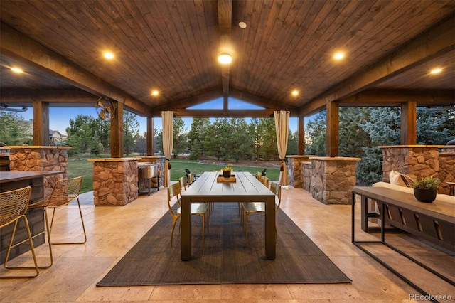 sunroom / solarium featuring beam ceiling