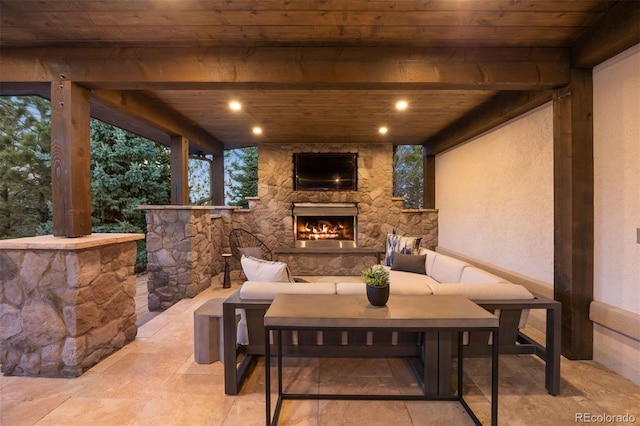 view of patio / terrace with an outdoor living space with a fireplace