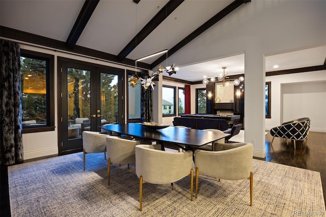 dining room featuring lofted ceiling with beams, wood finished floors, french doors, baseboards, and a notable chandelier