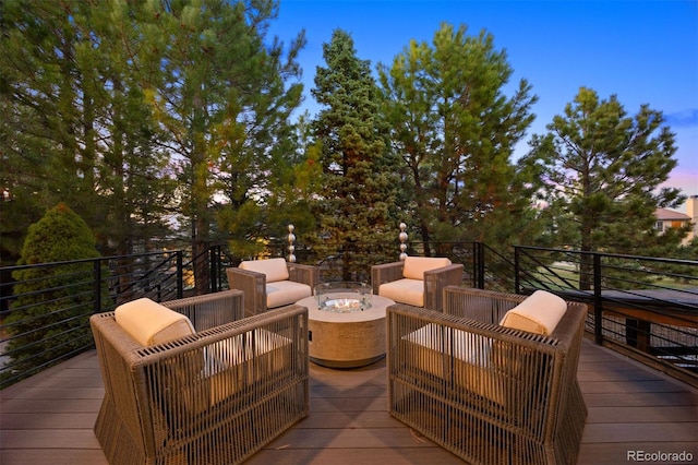 deck with an outdoor living space with a fire pit