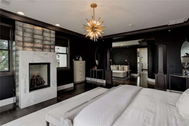 bedroom featuring a chandelier, baseboards, multiple windows, and visible vents