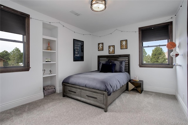 bedroom featuring visible vents, baseboards, and light colored carpet