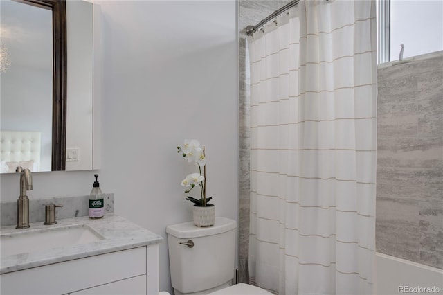 bathroom featuring shower / bath combo with shower curtain, vanity, and toilet
