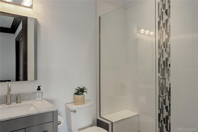 bathroom featuring vanity, a shower stall, and toilet