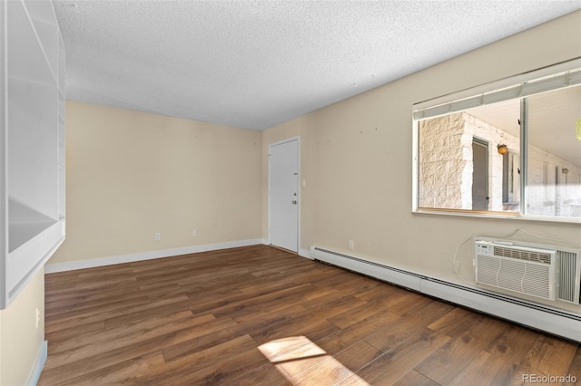 unfurnished room featuring a textured ceiling, dark hardwood / wood-style flooring, and a baseboard radiator