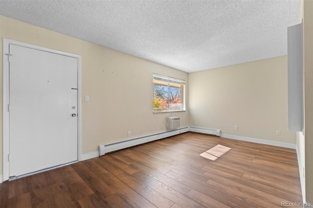 entryway with hardwood / wood-style floors, a textured ceiling, and a baseboard radiator