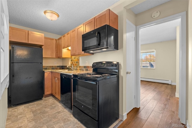 kitchen with a textured ceiling, light hardwood / wood-style flooring, baseboard heating, and black appliances