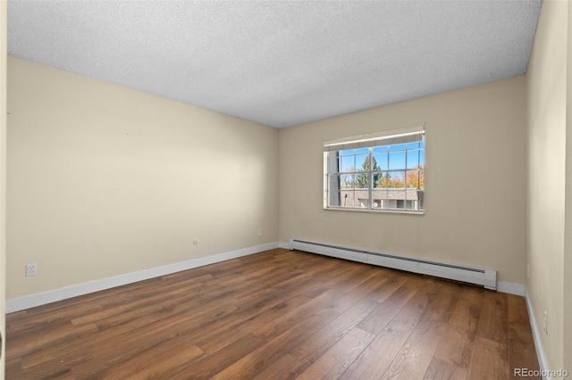 unfurnished room with baseboard heating, dark wood-type flooring, and a textured ceiling