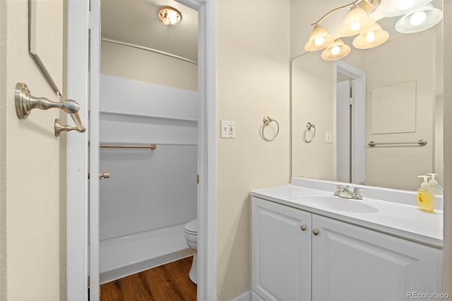 bathroom featuring vanity, hardwood / wood-style flooring, and toilet