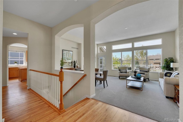20591 E Weaver Ave, Aurora, CO 80016 - living area with light wood-style flooring, arched walkways, and recessed lighting