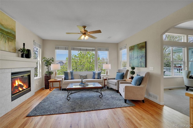 20591 E Weaver Ave, Aurora, CO 80016 - living room with plenty of natural light, wood finished floors, arched walkways, and a ceiling fan