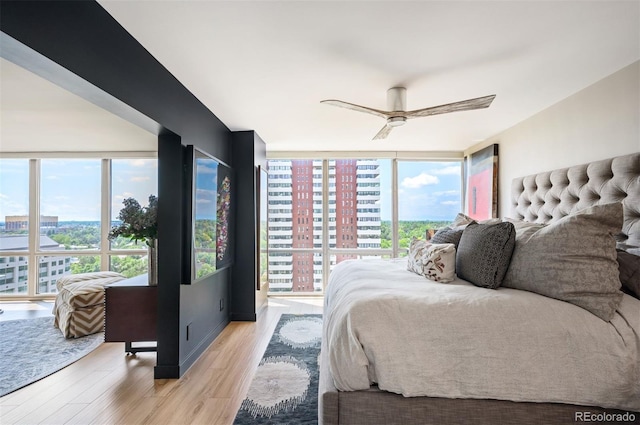 3100 E Cherry Creek S Drive 1403, Denver, CO 80209 - bedroom featuring light wood-type flooring, floor to ceiling windows, ceiling fan, and a city view