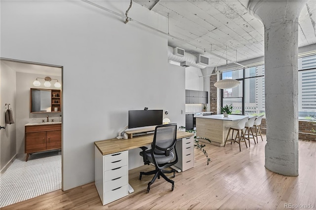 2000 Arapahoe St Unit 503, Denver, CO 80205 - home office featuring a sink and light wood-style flooring