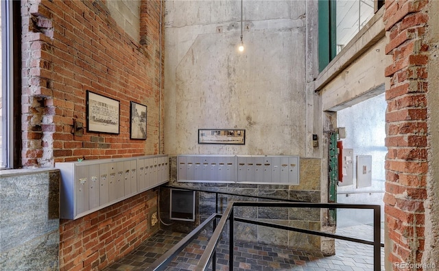 2000 Arapahoe St Unit 503, Denver, CO 80205 - kitchen with mail area, a high ceiling, brick floors, and brick wall