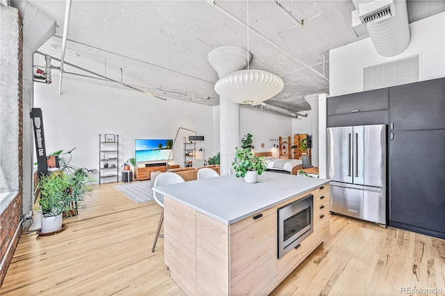 2000 Arapahoe St Unit 503, Denver, CO 80205 - kitchen with appliances with stainless steel finishes, light wood finished floors, and modern cabinets