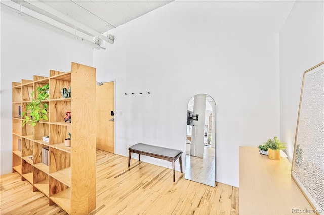 2000 Arapahoe St Unit 503, Denver, CO 80205 - hallway featuring arched walkways, wood finished floors, and a towering ceiling