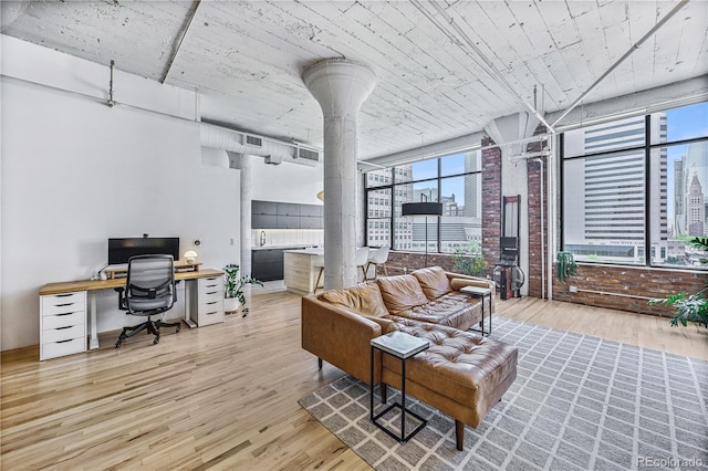 2000 Arapahoe St Unit 503, Denver, CO 80205 - living room featuring ornate columns, an office area, wood finished floors, and plenty of natural light