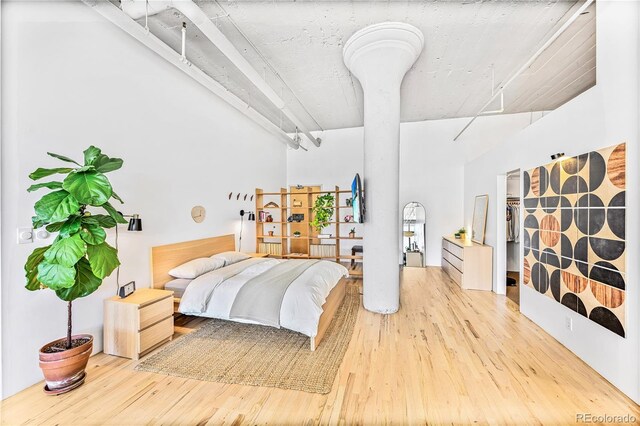 2000 Arapahoe St Unit 503, Denver, CO 80205 - bedroom featuring a towering ceiling and wood finished floors