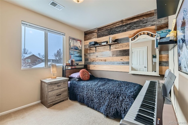 bedroom with carpet floors and wood walls