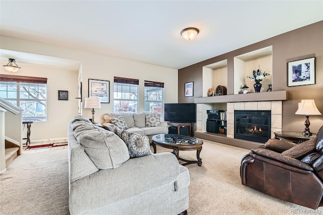 living room featuring a fireplace, a healthy amount of sunlight, and carpet flooring