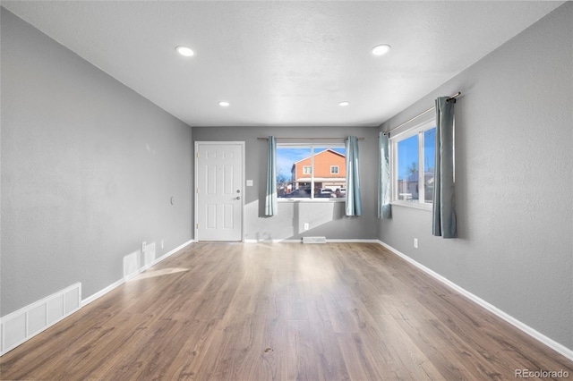 empty room featuring hardwood / wood-style floors and a textured ceiling