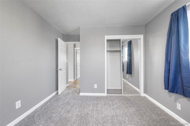 unfurnished bedroom featuring carpet floors and a closet