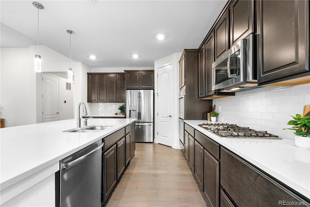 8814 S Winnipeg Ct, Aurora, CO 80016 - kitchen with appliances with stainless steel finishes, light countertops, dark brown cabinets, backsplash, and recessed lighting