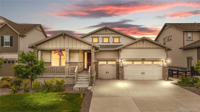 8814 S Winnipeg Ct, Aurora, CO 80016 - craftsman-style home featuring board and batten siding, covered porch, concrete driveway, and stone siding