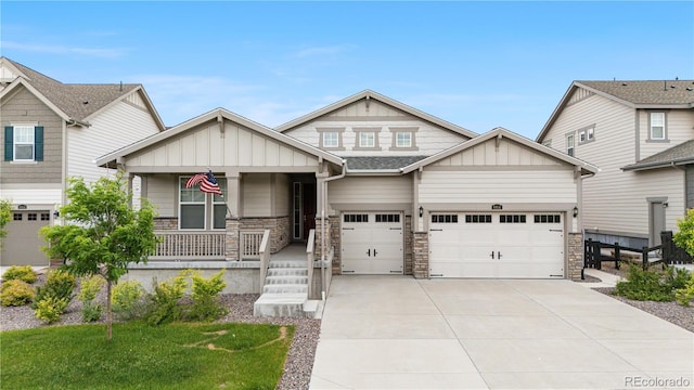 8814 S Winnipeg Ct, Aurora, CO 80016 - craftsman-style home with a porch, concrete driveway, board and batten siding, and stone siding