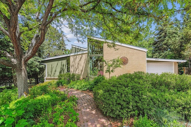 9113 E Evans Way, Denver, CO 80231 - view of side of property featuring brick siding and a garage