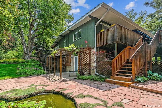 9113 E Evans Way, Denver, CO 80231 - rear view of house with stairway, a patio area, and a deck