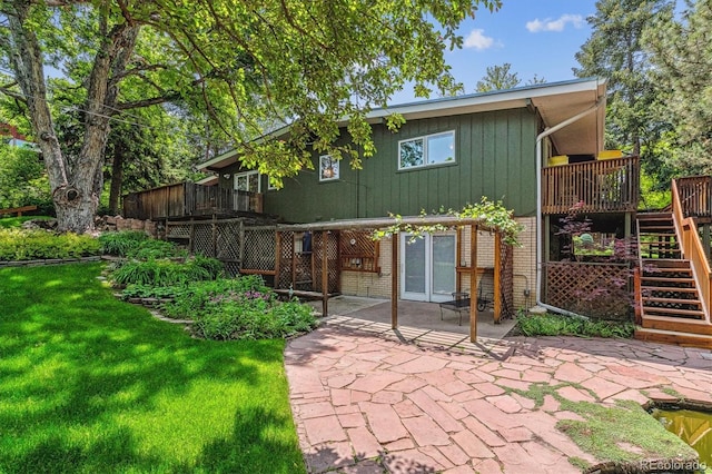 9113 E Evans Way, Denver, CO 80231 - rear view of property with stairs, a patio area, brick siding, a deck, and a lawn