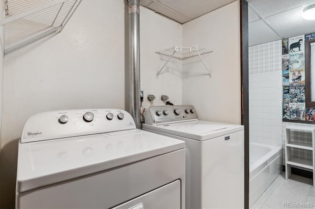 9113 E Evans Way, Denver, CO 80231 - washroom with washing machine and clothes dryer and light tile patterned flooring