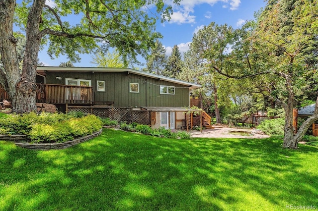 9113 E Evans Way, Denver, CO 80231 - back of property featuring a patio area, a deck, stairway, and a yard