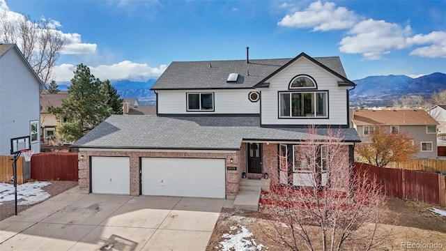 front facade featuring a mountain view and a garage