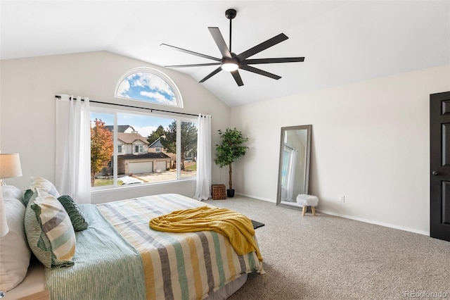 carpeted bedroom with ceiling fan and vaulted ceiling