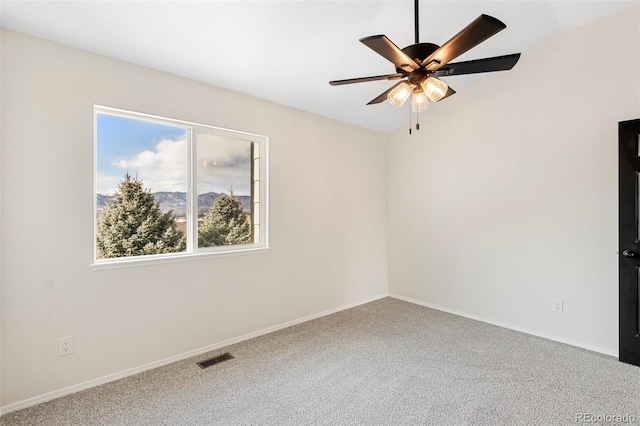 spare room with carpet flooring and ceiling fan