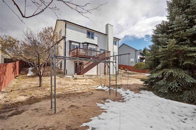 snow covered property with a deck