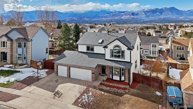 view of front of property with a mountain view and a garage