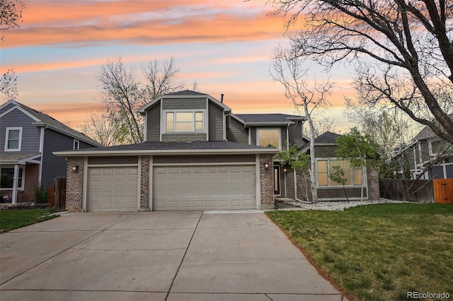 view of front of house with driveway, a garage, brick siding, fence, and a yard