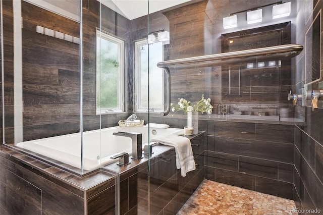 full bathroom with a tile shower and a garden tub