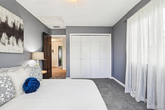 bedroom with attic access, visible vents, baseboards, a closet, and carpet flooring