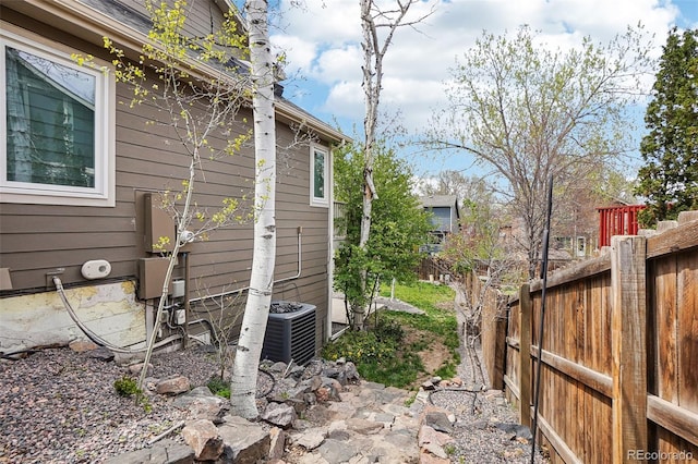 view of home's exterior featuring fence and central AC