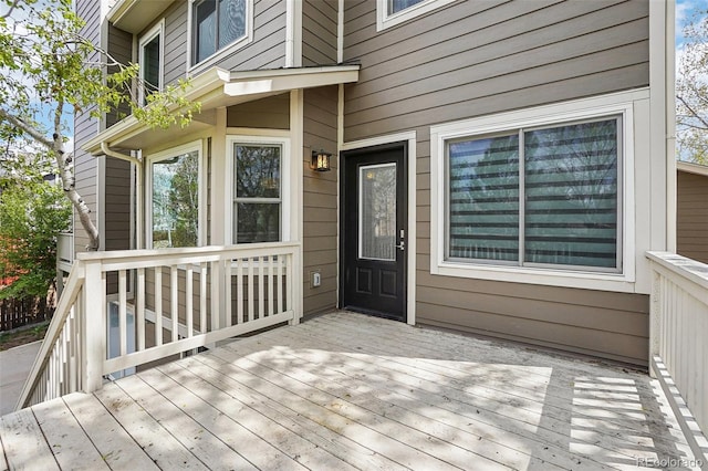 view of exterior entry featuring a wooden deck