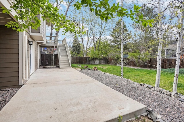 view of patio featuring stairs and a fenced backyard