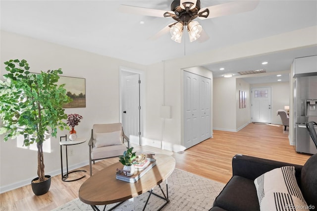 living room featuring light hardwood / wood-style floors and ceiling fan