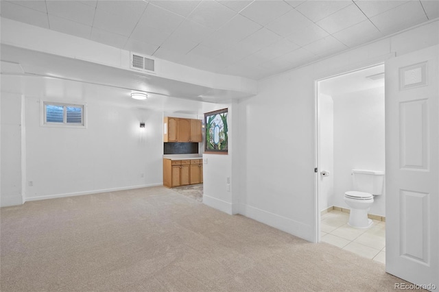 unfurnished living room with light colored carpet